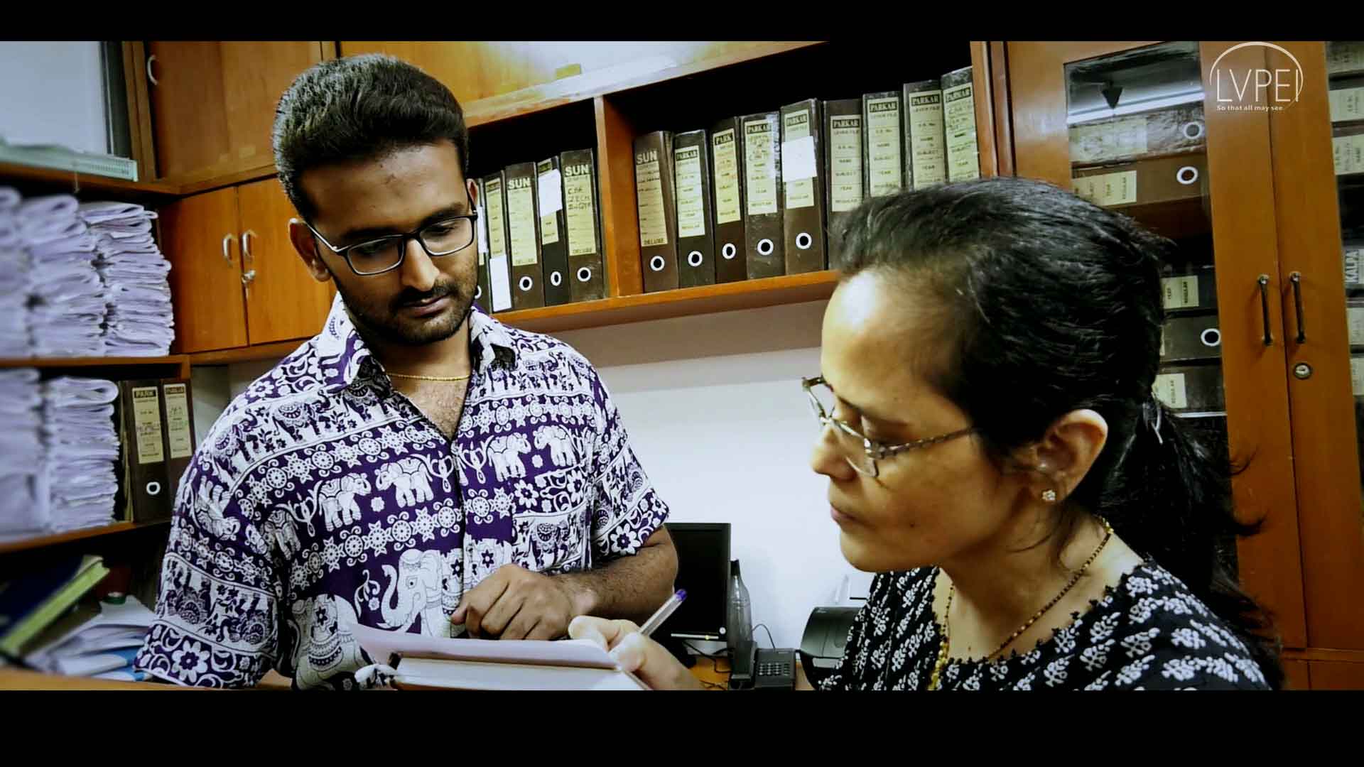 A volunteer helping a user with paper work