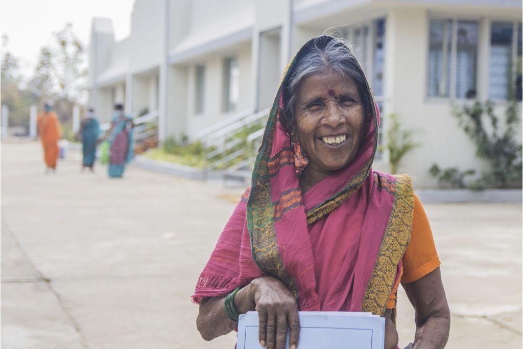Smiling old lady from Mudhol in pink sari.