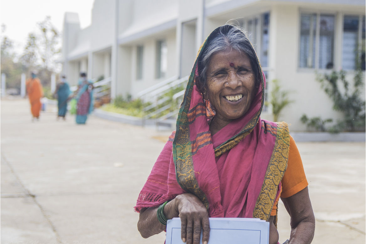 Smiling old lady from Mudhol in pink sari.